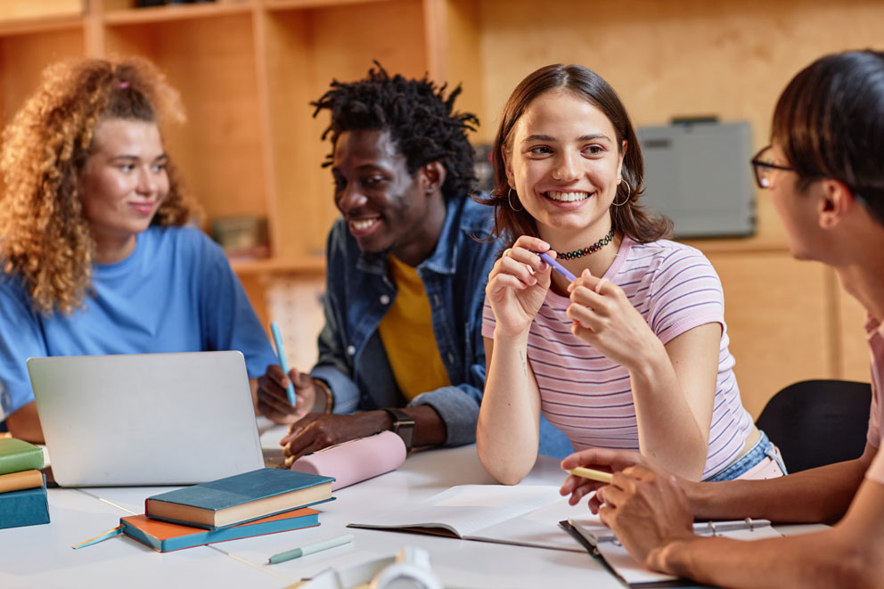 Mixed group of smiling students talking